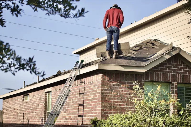 Professional roofer working on a residential roof in Hamline